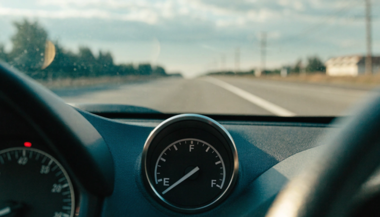 close up photo of a car dashboard fuel gauge showi